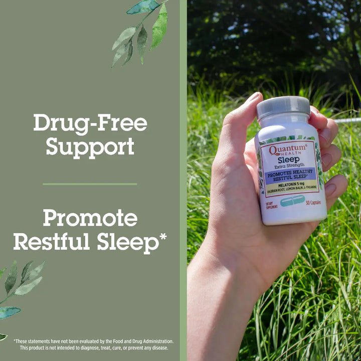 Hand holding a bottle of Quantum Sleep supplement with a natural background