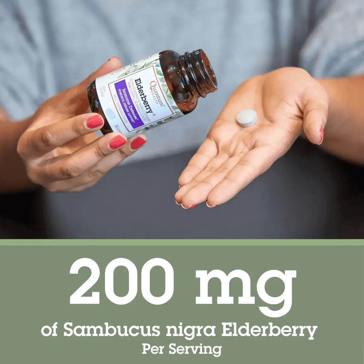 Person holding a bottle of Elderberry supplement with a lozenge in their hand, against a neutral background. 
