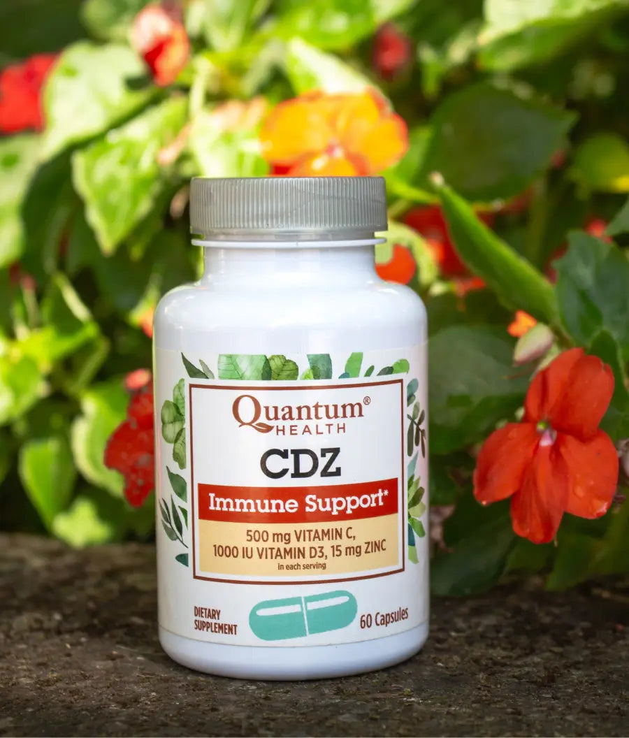 Quantum Health CDZ Immune Support supplement bottle with flowers in the background